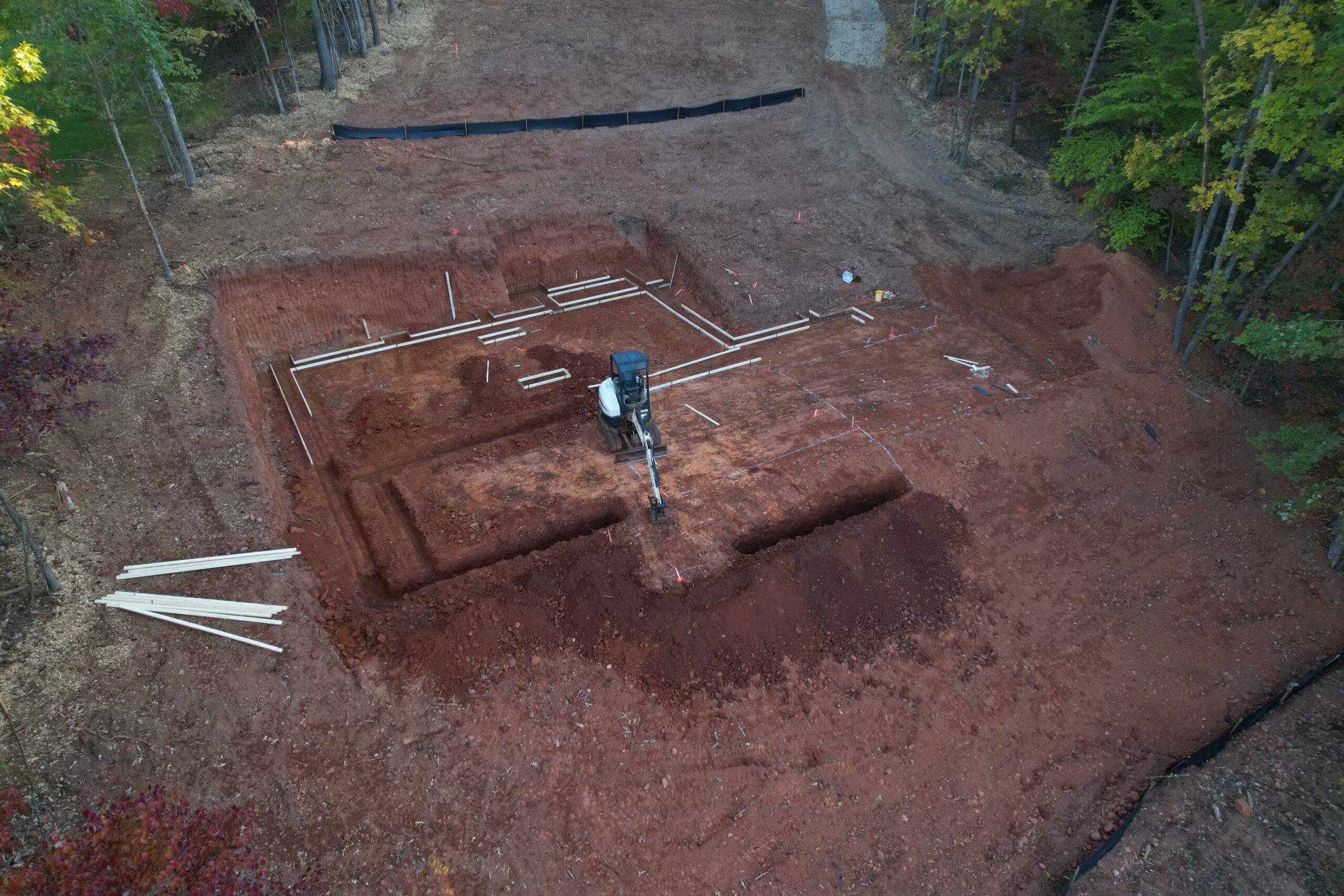 Foundation excavation and footer layout on a lakefront lot with Virginia red clay soil