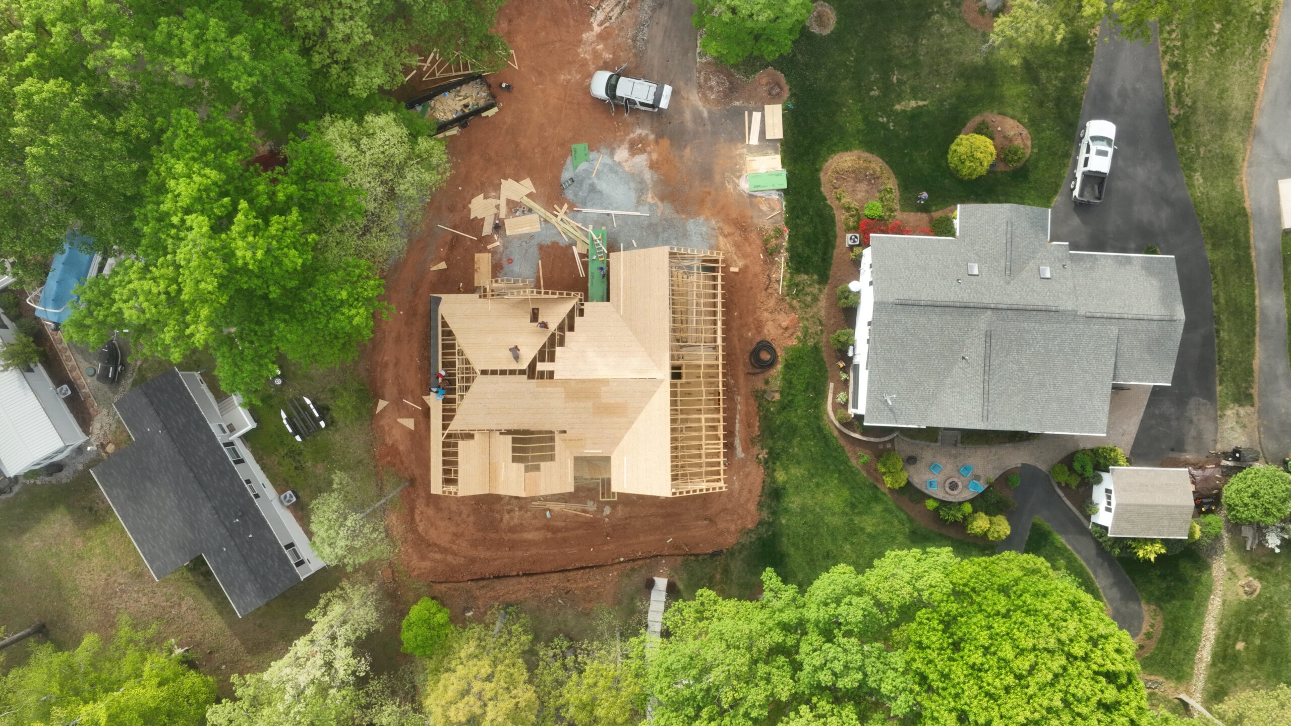 Aerial view of a custom home framed on an open site with significant weather exposure